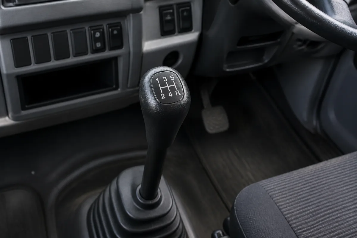 Synchromesh manual gear stick inside a right-hand-drive heavy truck cab